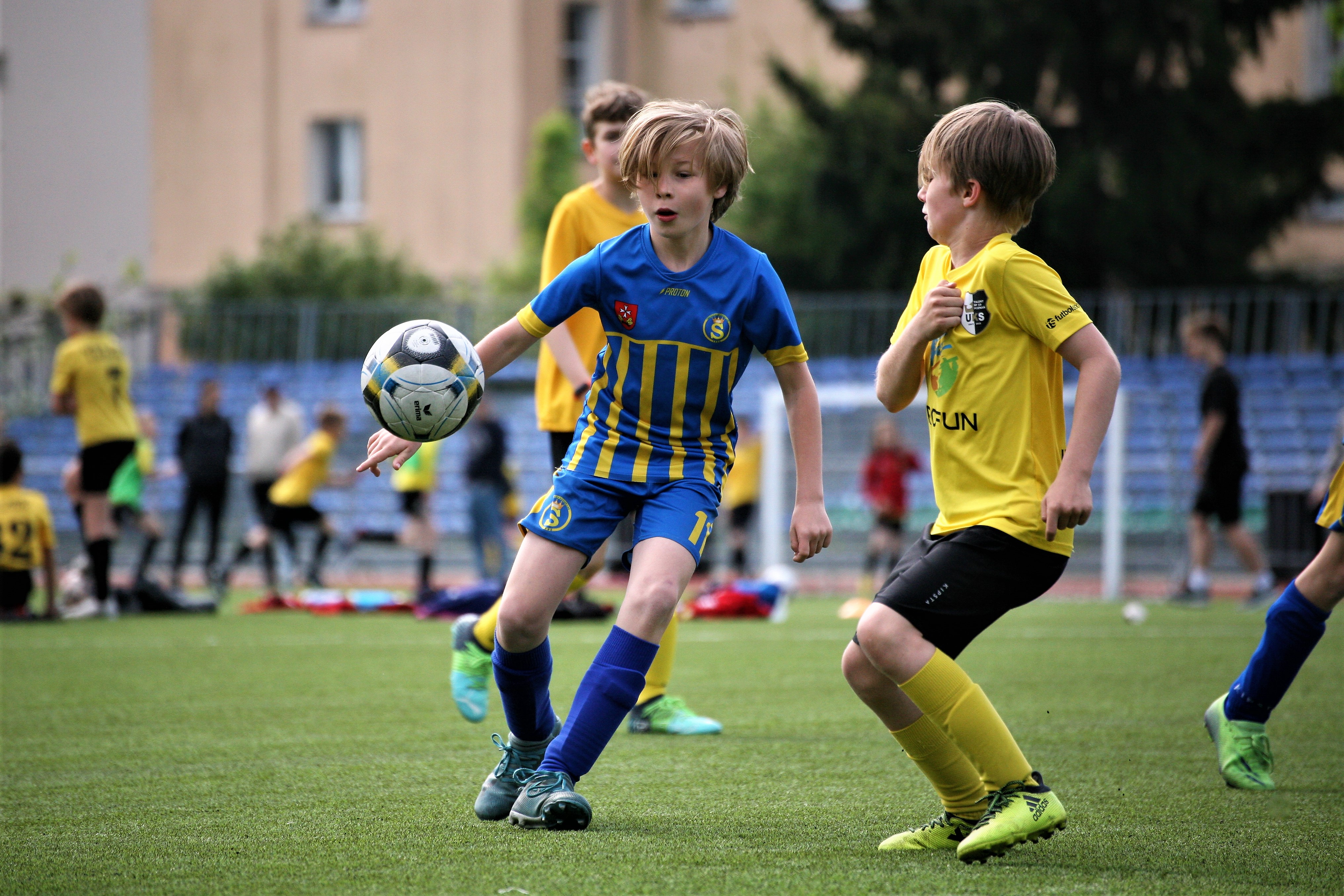 Chłopcy grają w piłkę na boisku Młodzieżowego Ośrodka Sportowego